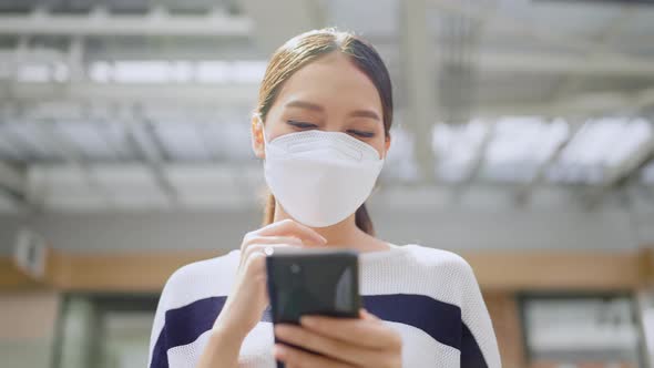 casual lifestyle technology,asian female woman wear facemask walking happiness outdoor alt