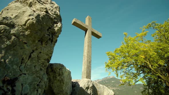 Cross Monument Stands on Pile of Big Stones in Italy alt