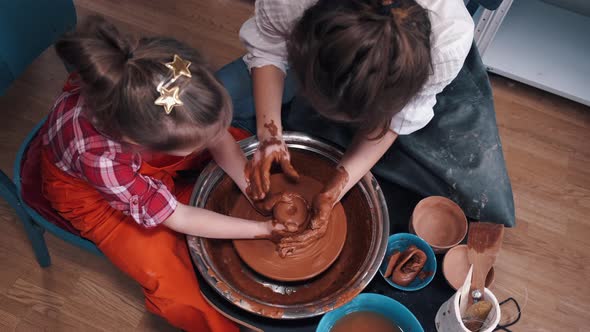 Ceramic Artist Teaching Kid How To Create Ceramics alt