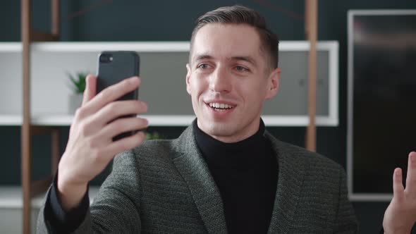 Smiling Business Man Having Video Call on Smartphone