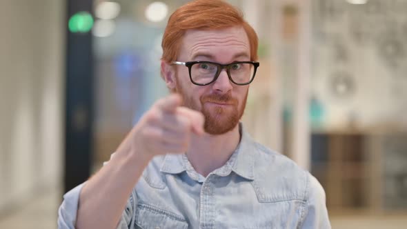 Assertive Young Redhead Man with Pointing and Inviting alt
