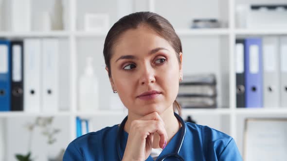 Professional medical doctor working in hospital office. Young and attractive female physician. alt