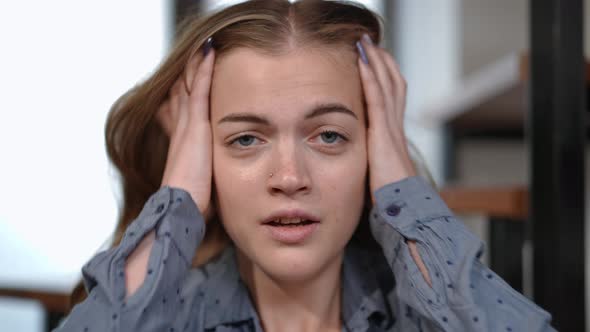 Headshot Stressed Teenage Girl with Panic Attack Breathing Heavily Looking at Camera Holding Head in alt