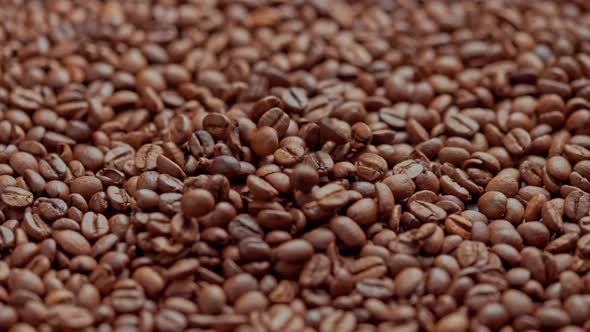 Roasted Coffee Beans Drop in Slow Motion on Full Frame Background of Coffe Beans alt