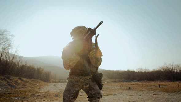 Special operations soldier of fur seals reloads an M-16 carbine in the desert alt