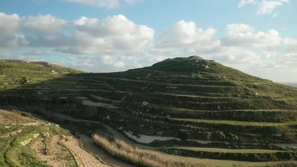 AERIAL: Sunny Hill near Migra i ferha Ravine in Malta