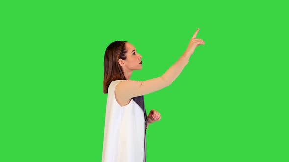 Robotic Girl Stands Operating Virtual Monitors on a Green Screen Chroma Key
