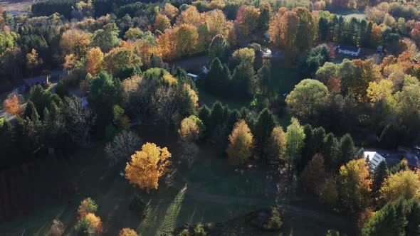Aerial Drone Shot Flying Over Farm and Tilting Up to Reveal Fall Sunset