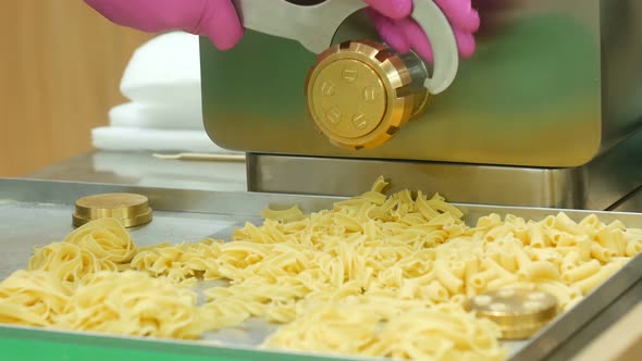 Cook Uses Machine To Make Noodles