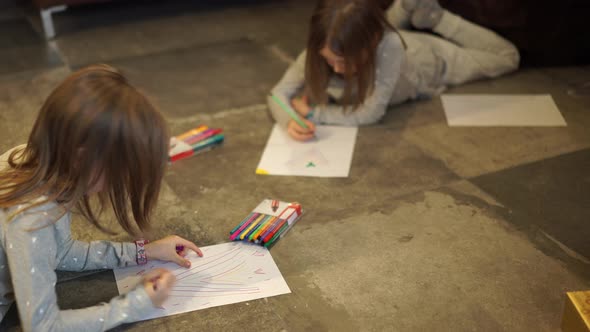 Children Drawing on Floor in Living Room