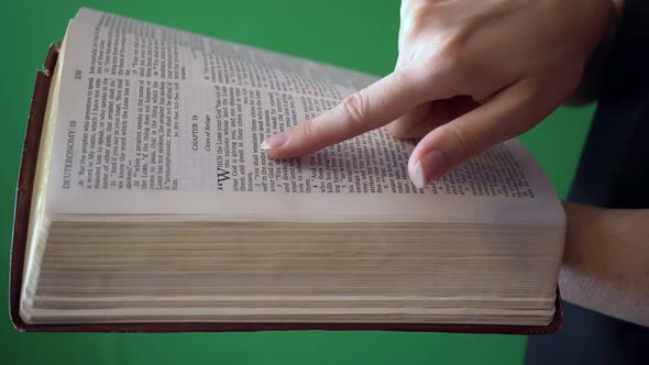 Girl Reading Bible Isolated On Chroma Key Green Screen Background alt