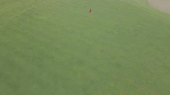 Drone Flying Away From Red Flag on Golf Course