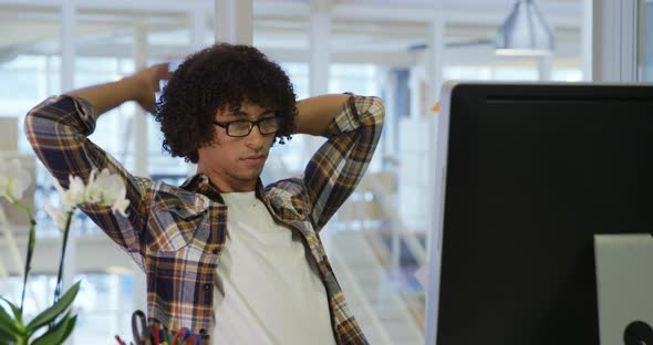 Young man working in a creative office alt