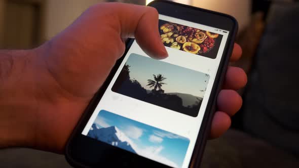 Man Using Smartphone Scrolling Through Social Network Feed Doing Swiping Scrolling Gestures alt