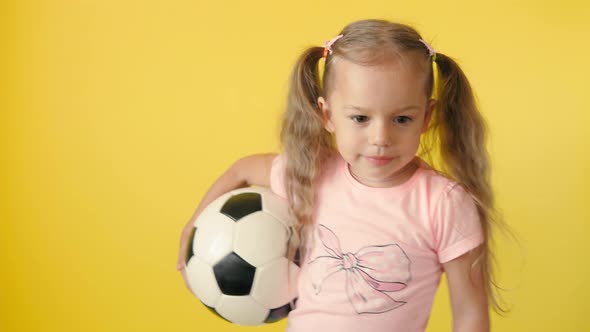 Authentic Cute Smiling Preschool Little Girl with Classic Black and White Soccer Ball Look at Camera alt
