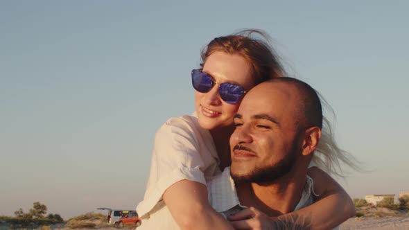 Young Beautiful Couple in Love Standing and Hugging on Beach By the Sea