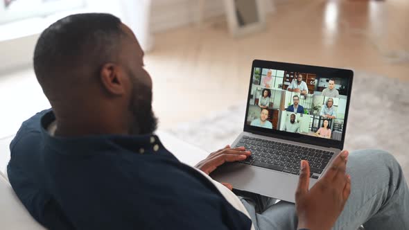 Back View on the Laptop Screen with a Many Diverse People on It alt