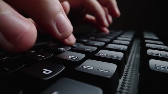 Close-up typing on keyboard with man fingers. Macro soft focus dolly shot. alt