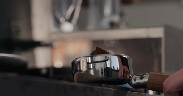 Slow Motion Spreading Fresh Ground Coffee in Basket of Bottomless Portafilter alt