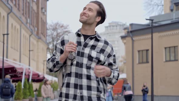 Happy man with backpack.