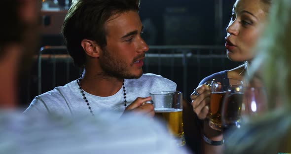 Couple having mug of beer at a concert 4k alt
