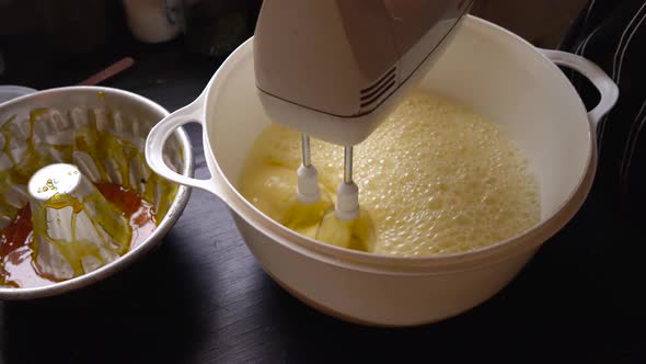 Homemade cake flan mixture, electric whisk mixer aerating mixture alt