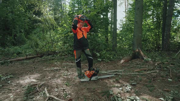 Portrait of a Woman Logger Standing in the Forest Female Specialist in Protective Gear Puts on alt