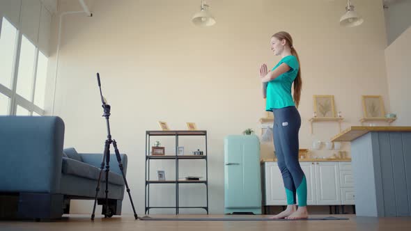 Athletic Woman Conducts Training Online. Concept Exercise at Home Via Smartphone. alt