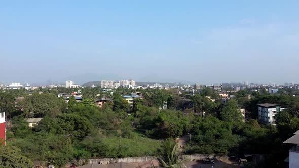 Trees and buildings are seen as drone fly over city in India