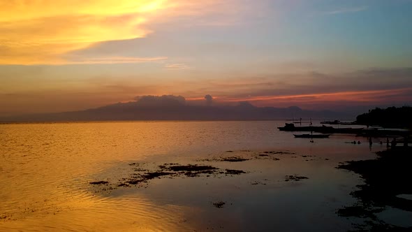 Aerial of epic Sunset over the sea from Paliton Beach, Siquijor, Cebu, Philippines