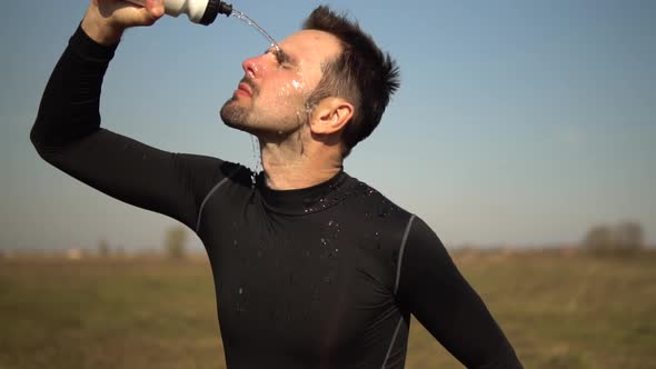 Athlete Cooling Down After Jogging Training On Trail.Tired Triathlete Jogger Relaxing After Workout. alt