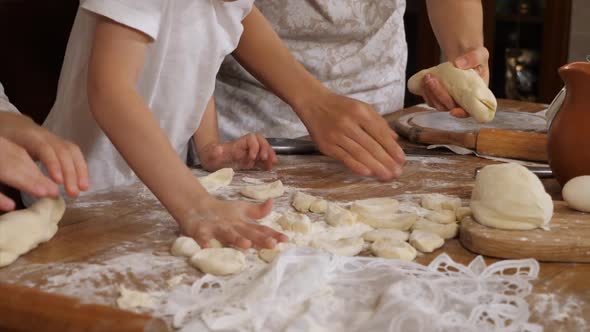 Children Helping Parents to Preparing a Dough in Domestic Kitchen
