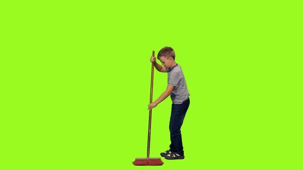 Little Boy Sweeps the Floor with Mop 