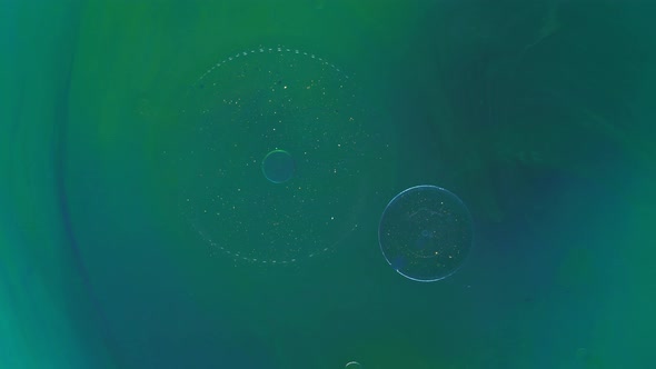 Moving Background Consisting of Blue and Green Particles of the Current Paint on a White Background alt