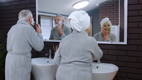 Old Senior Couple Man and Woman Doing Morning Hygiene Procedures and Looking Into a Mirror alt