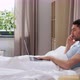Man with Folder Calling on Phone in Bed at Home - VideoHive Item for Sale