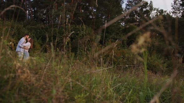 A Beautiful Girl and Boy Hugging in a Park alt