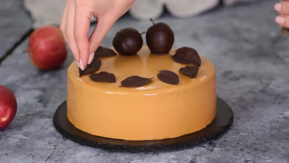 Pastry Chef Decorating Mousse Cake Small Chocolate Pieces alt