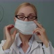 Portrait of Female Medical Doctor in Glasses Putting on Mask Indoors - VideoHive Item for Sale