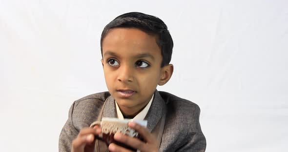 one Pakistani kid drinks a tea alt