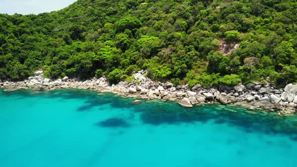 Calm Sea Near Tropical Volcanic Island. Drone View of Peaceful Water of Blue Sea Near Stony Shore alt