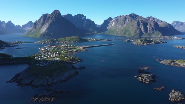 Flight over the sea and view on the fishing village Reine and Hamnoya ,Lofoten Islands, Norway
