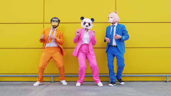 Business people in vibrant suits and animal masks dancing happily
