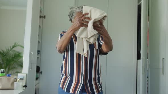 Animation of african american senior woman packing suitcase for travel alt