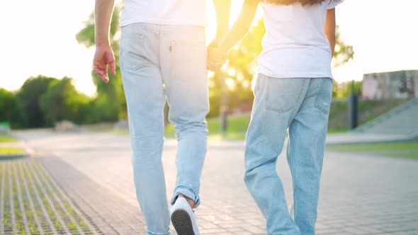 Dad and Daughter Walk Around Their Area at Sunset alt