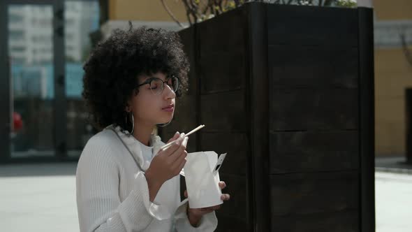 African american girl eating lunch outdoors alt
