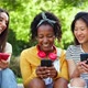Multiracial Female Friends Having Fun Using Mobile Phone Together Outdoors - VideoHive Item for Sale