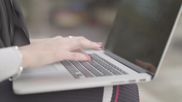 Close Up Shot Of Woman Typing On Keyboard Whilst Working Outside , In Slowmotion - Ungraded alt