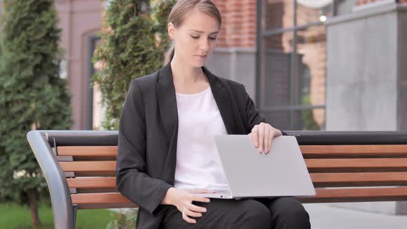Young Businesswoman Coming and Sitting on Bench to Use Laptop alt