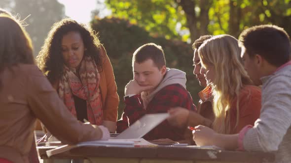 Group of college students on campus meeting outdoors